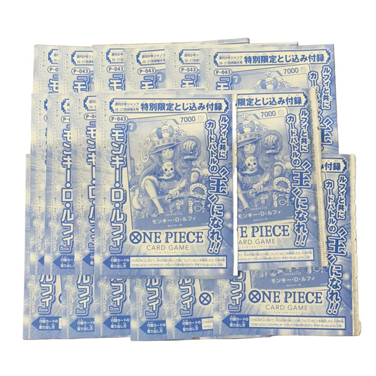 Multiple 'One Piece' anime promo magazine inserts stacked on a wooden surface
